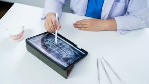 Dentist In Clinic Examines X Ray Of Jaw