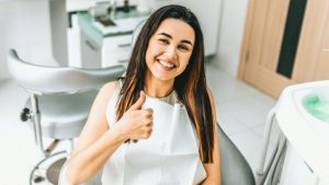 Women Sitting In A Chair Giving A Thumbs Up