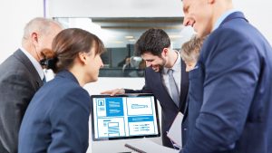 Business Team Analyzing Data on a Computer Screen